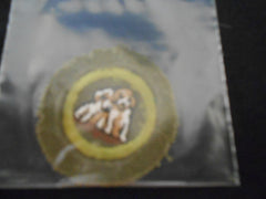 Dog Care Khaki Crimped Edge Merit Badge, worn